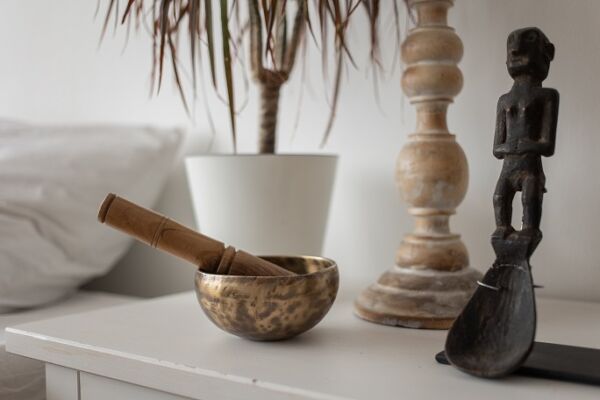 brass singing bowl sitting on a nightstand
